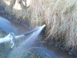 Flushing sand and silt from recently installed land drain